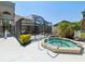 Community hot tub and screened lanai area with lush landscaping at 11536 Golden Rain Dr, New Port Richey, FL 34654
