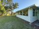 Spacious backyard with a well-kept lawn, mature trees, and a peaceful view of the surrounding area at 11648 Boynton Ln # 39Gb, New Port Richey, FL 34654