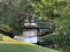 Scenic view of backyard creek with a charming wooden bridge amidst lush greenery and a reflection of nature at 11648 Boynton Ln # 39Gb, New Port Richey, FL 34654