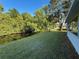 Lush backyard featuring tranquil creek frontage, mature trees, and well-maintained lawn space at 11648 Boynton Ln # 39Gb, New Port Richey, FL 34654
