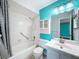 Bathroom with shower and tub combination, vanity, and turquoise blue accent wall at 11648 Boynton Ln # 39Gb, New Port Richey, FL 34654