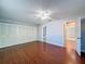 Bedroom featuring hardwood floors, a closet, and an en suite bathroom at 11648 Boynton Ln # 39Gb, New Port Richey, FL 34654