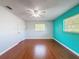Empty bedroom with hardwood floors, ceiling fan, and natural light from the windows at 11648 Boynton Ln # 39Gb, New Port Richey, FL 34654