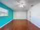This bedroom features hardwood floors, a ceiling fan, a closet, and an en suite bathroom at 11648 Boynton Ln # 39Gb, New Port Richey, FL 34654