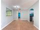 Open living area with tile flooring, a window, and an arched entrance to the kitchen at 11648 Boynton Ln # 39Gb, New Port Richey, FL 34654