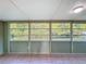 Sunroom with beadboard walls and many windows offer bright natural light and peaceful view of the surrounding nature at 11648 Boynton Ln # 39Gb, New Port Richey, FL 34654