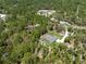 Overhead view of a beautiful home on a large wooded lot featuring a long driveway and park-like setting at 11730 Hawks Nest Trl, Brooksville, FL 34614