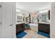 Bathroom with double vanities, soaking tub, and stylish fixtures at 11730 Hawks Nest Trl, Brooksville, FL 34614