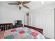 This bedroom has a ceiling fan, closet, a wooden bed frame, and a TV at 11730 Hawks Nest Trl, Brooksville, FL 34614