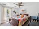 Bright bedroom featuring a wooden bed frame, a window, and cozy carpeting for a comfortable living space at 11730 Hawks Nest Trl, Brooksville, FL 34614