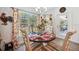 Charming dining area with large window and decorative toile curtains showcasing the beautiful view at 11730 Hawks Nest Trl, Brooksville, FL 34614