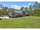 Charming single-story home with a well-manicured lawn, tasteful landscaping, and a welcoming facade at 11730 Hawks Nest Trl, Brooksville, FL 34614