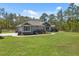 Inviting home with lush lawn, mature trees, and well-manicured landscaping enhancing the curb appeal at 11730 Hawks Nest Trl, Brooksville, FL 34614
