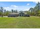 Beautiful home with a manicured lawn and an inviting front porch perfect for enjoying the serene surroundings at 11730 Hawks Nest Trl, Brooksville, FL 34614