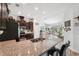 Bright kitchen with granite countertops, stainless steel appliances, and a breakfast bar overlooking the living room at 11730 Hawks Nest Trl, Brooksville, FL 34614