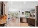 Open-concept kitchen featuring granite countertops, wood cabinetry, and stainless steel appliances at 11730 Hawks Nest Trl, Brooksville, FL 34614