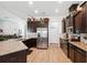 Spacious kitchen featuring granite countertops, stainless steel appliances, and wood-look tile flooring at 11730 Hawks Nest Trl, Brooksville, FL 34614