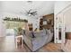 Cozy living room featuring a brick fireplace, built-in shelving, and lots of natural light at 11730 Hawks Nest Trl, Brooksville, FL 34614