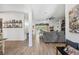 Bright living room featuring wood look tile floors, a ceiling fan, and open concept design at 11730 Hawks Nest Trl, Brooksville, FL 34614
