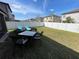 Spacious backyard with manicured lawn, patio furniture and privacy fence at 11796 Crestridge Loop, New Port Richey, FL 34655