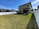 Backyard with patio furniture, manicured lawn and privacy fence at 11796 Crestridge Loop, New Port Richey, FL 34655