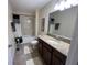 Standard bathroom with granite counters, shower-tub combo with curtain, and neutral decor at 11796 Crestridge Loop, New Port Richey, FL 34655