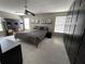 This spacious bedroom features a ceiling fan, dark-toned closet, and two windows with lots of light at 11796 Crestridge Loop, New Port Richey, FL 34655