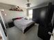 Comfortable bedroom with carpet, fan, and window for natural light at 11796 Crestridge Loop, New Port Richey, FL 34655