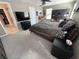 This bedroom has modern style with a ceiling fan, closet, and a large TV on top of a dresser at 11796 Crestridge Loop, New Port Richey, FL 34655