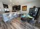 Dining area with granite bar, dining table with seating, and black decorative shelving at 11796 Crestridge Loop, New Port Richey, FL 34655