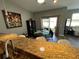 Kitchen area with barstool seating and dining table with seating next to sliding glass doors at 11796 Crestridge Loop, New Port Richey, FL 34655