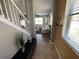 Hallway with view into living room with white leather furniture and lots of natural light at 11796 Crestridge Loop, New Port Richey, FL 34655