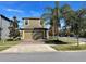 Charming home with a two-car garage, brick-paved driveway, and landscaped front yard at 11796 Crestridge Loop, New Port Richey, FL 34655
