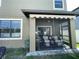 View of rear of home with screened patio, grassy backyard, and privacy fence at 11796 Crestridge Loop, New Port Richey, FL 34655