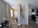 Foyer with staircase, tile and wood flooring, and access to the living spaces at 11796 Crestridge Loop, New Port Richey, FL 34655