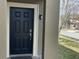 Elegant black front door with a white trim offers a welcoming entrance to the home at 11796 Crestridge Loop, New Port Richey, FL 34655