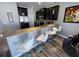 Modern kitchen with black cabinets and bar seating at a granite countertop peninsula at 11796 Crestridge Loop, New Port Richey, FL 34655