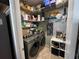 Well-organized laundry room with shelving, storage space, and modern washer and dryer units at 11796 Crestridge Loop, New Port Richey, FL 34655