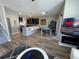 Open-concept living space with breakfast bar, dining area, and television with electric fireplace at 11796 Crestridge Loop, New Port Richey, FL 34655