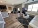Open-concept living space featuring a large sectional sofa and view of the kitchen area at 11796 Crestridge Loop, New Port Richey, FL 34655