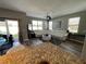 Living room with modern gray walls and bright white furniture with a gray textured rug at 11796 Crestridge Loop, New Port Richey, FL 34655