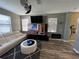 Living room with TV, white leather sofa and coffee table over a patterned gray rug at 11796 Crestridge Loop, New Port Richey, FL 34655