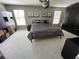 Well-lit bedroom with neutral carpeting, a ceiling fan, and ample closet space at 11796 Crestridge Loop, New Port Richey, FL 34655