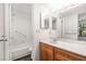 Bathroom featuring a single sink vanity and tub with shower at 1208 Cypress Pond Rd, Palm Harbor, FL 34683
