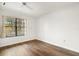 Bright, minimalist bedroom with wood floors and a large window at 1208 Cypress Pond Rd, Palm Harbor, FL 34683