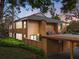 Inviting multi-level condo featuring wood siding, a covered parking area, and well-maintained landscaping at 1208 Cypress Pond Rd, Palm Harbor, FL 34683