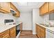 Kitchen with wooden cabinets, white countertops, and modern appliances at 1208 Cypress Pond Rd, Palm Harbor, FL 34683