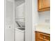 Convenient laundry closet with stacked washer and dryer unit at 1208 Cypress Pond Rd, Palm Harbor, FL 34683