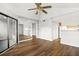 Open-concept living space with wood floors, natural light, seamlessly connecting the kitchen and sunroom at 1208 Cypress Pond Rd, Palm Harbor, FL 34683