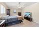 Comfortable bedroom with neutral tones and tile flooring provides a cozy space to relax and unwind at 1216 Yawl Way, Venice, FL 34285